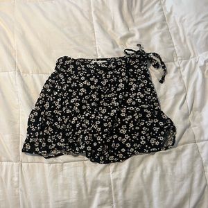 Black, flower detailed skirt that overlaps and ties on the side from Aeropostal.